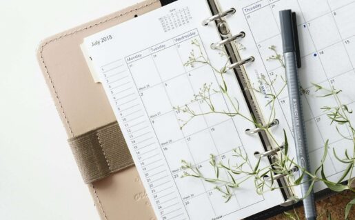 grey and black pen on calendar book